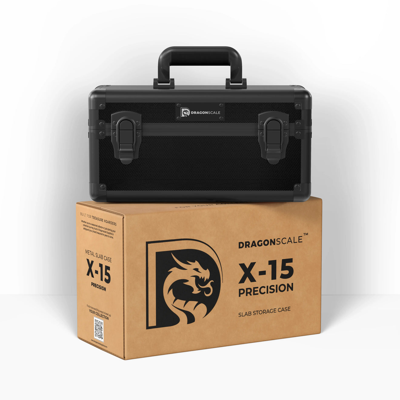 Display and demo view of the Dragonscale X-15 Precision metal slab case in carbon black, placed on top of its branded cardboard packaging box.