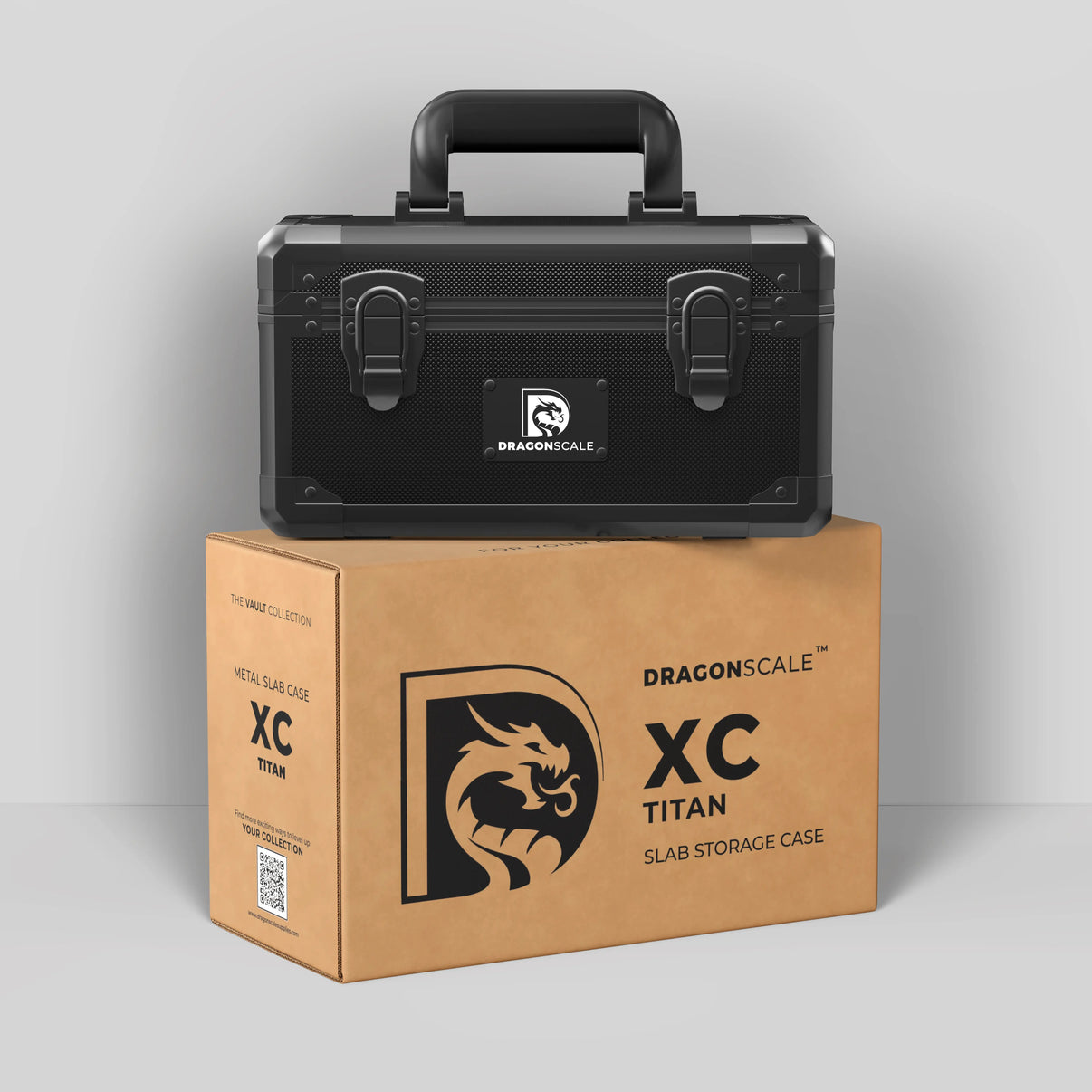 Display and demo view of the Dragonscale XC-Titan metal slab case in carbon black, placed on top of its branded cardboard packaging box.