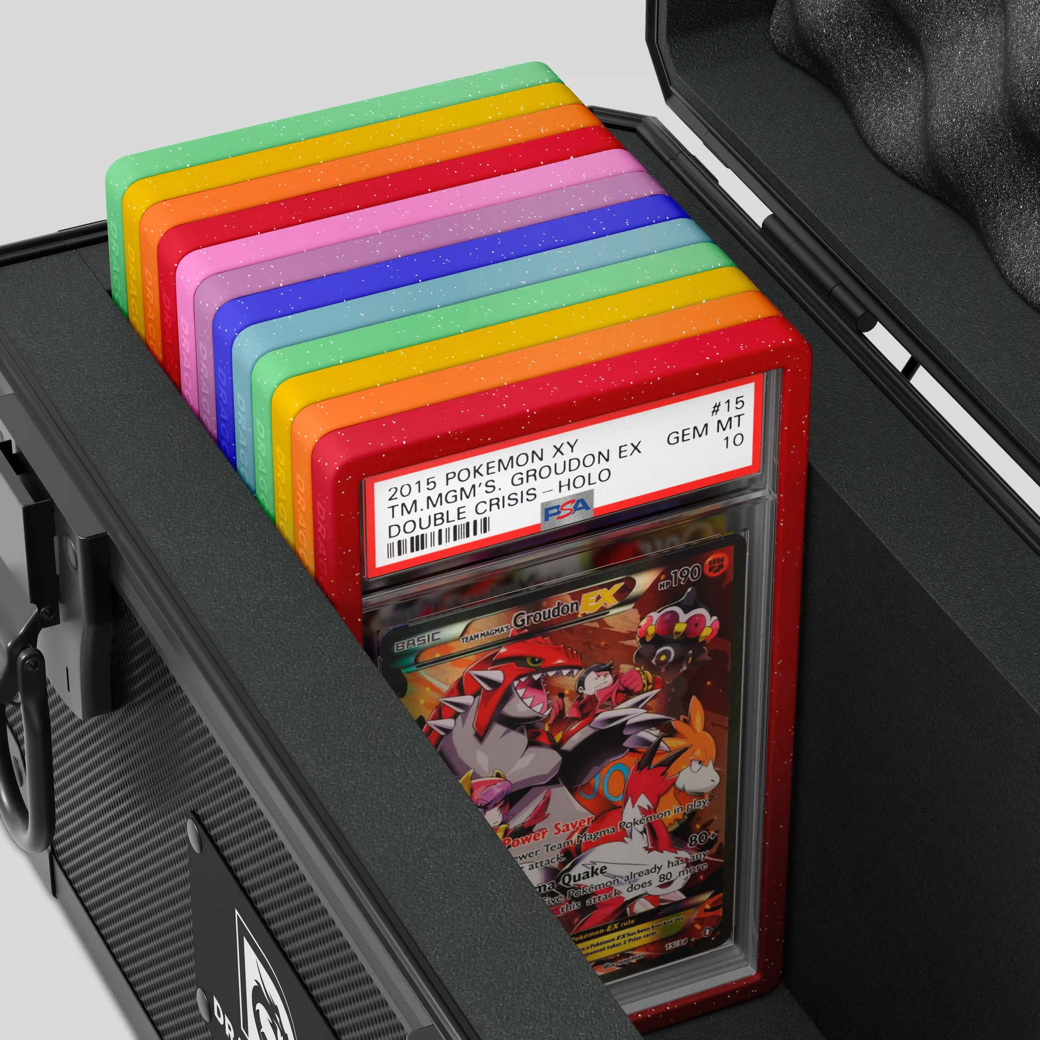 Close-up of the Dragonscale XC-Titan metal slab case in carbon black foam slot securely holding PSA slabs with Dragonscale guards.