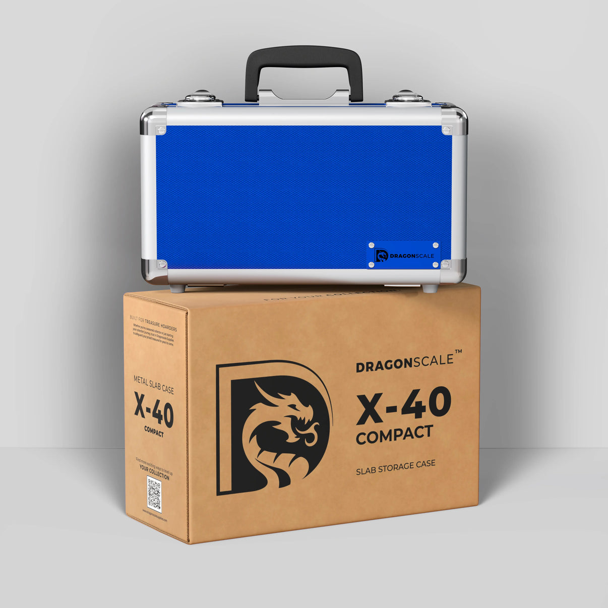 Display and demo view of the Dragonscale Basilisk X-40 Compact metal slab case in sapphire blue, placed on top of its branded cardboard packaging box.