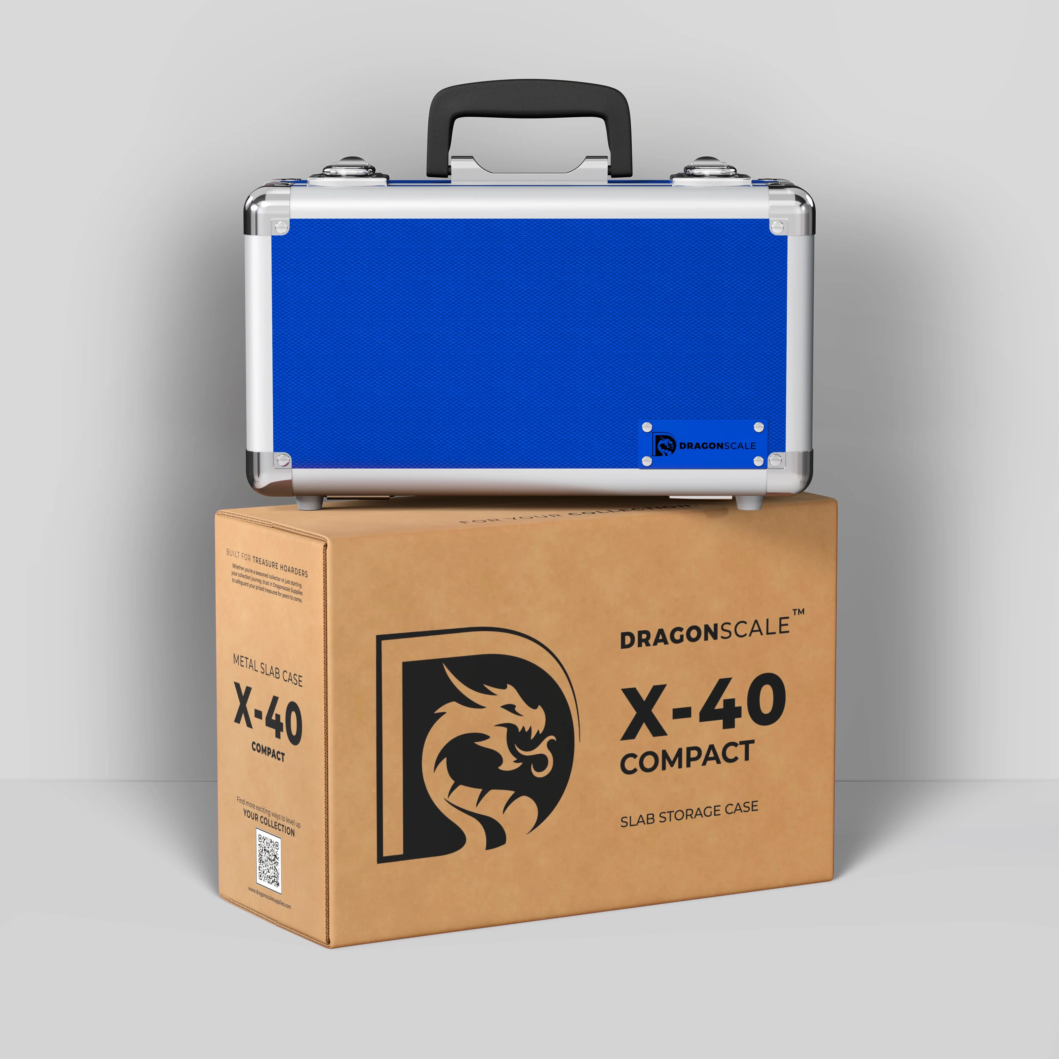 Display and demo view of the Dragonscale Basilisk X-40 Compact metal slab case in sapphire blue, placed on top of its branded cardboard packaging box.