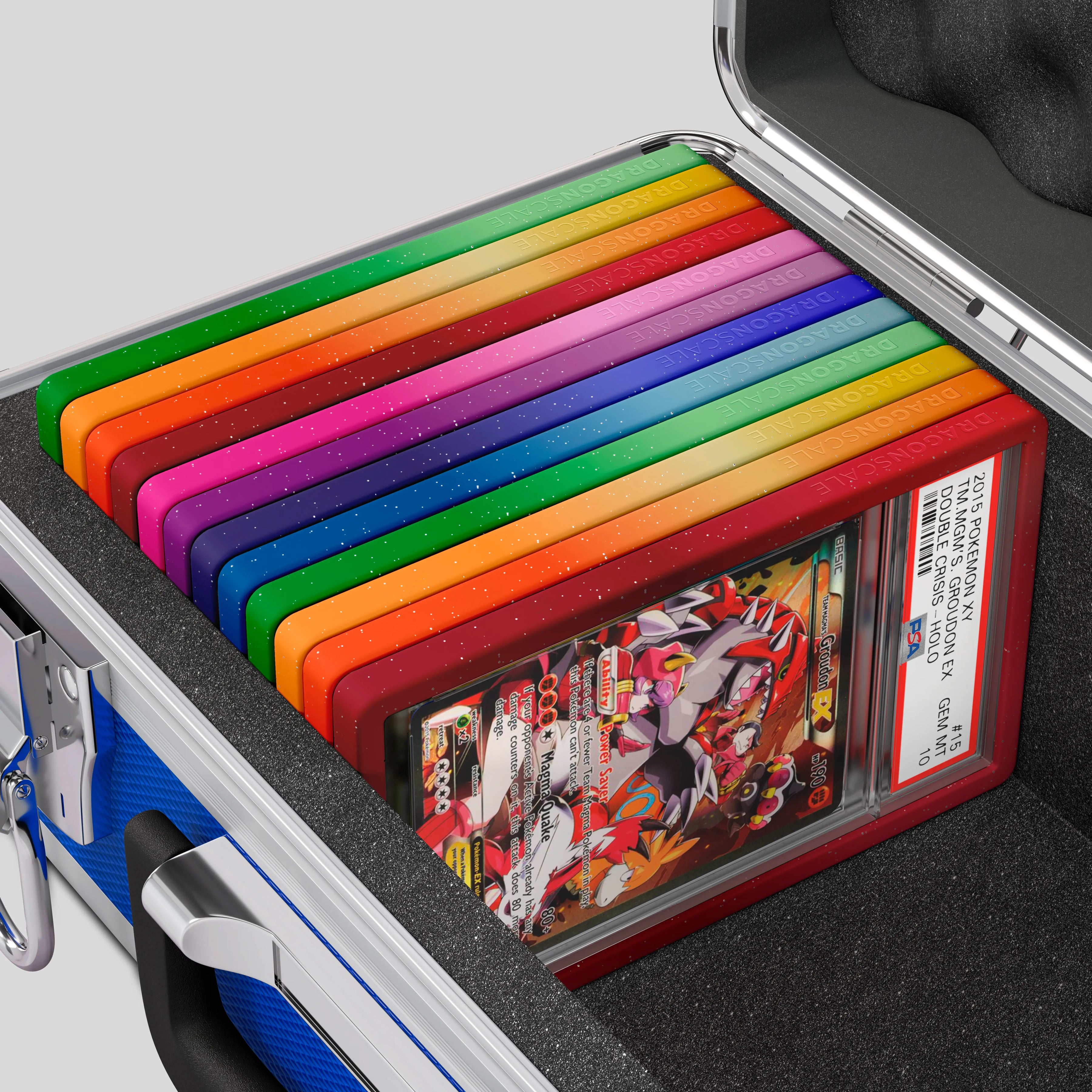 Close-up of the Dragonscale Basilisk X-40 Compact metal slab case in sapphire blue foam slot securely holding PSA slabs with Dragonscale guards.