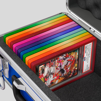 Close-up of the Dragonscale Basilisk X-40 Compact metal slab case in sapphire blue foam slot securely holding PSA slabs with Dragonscale guards.