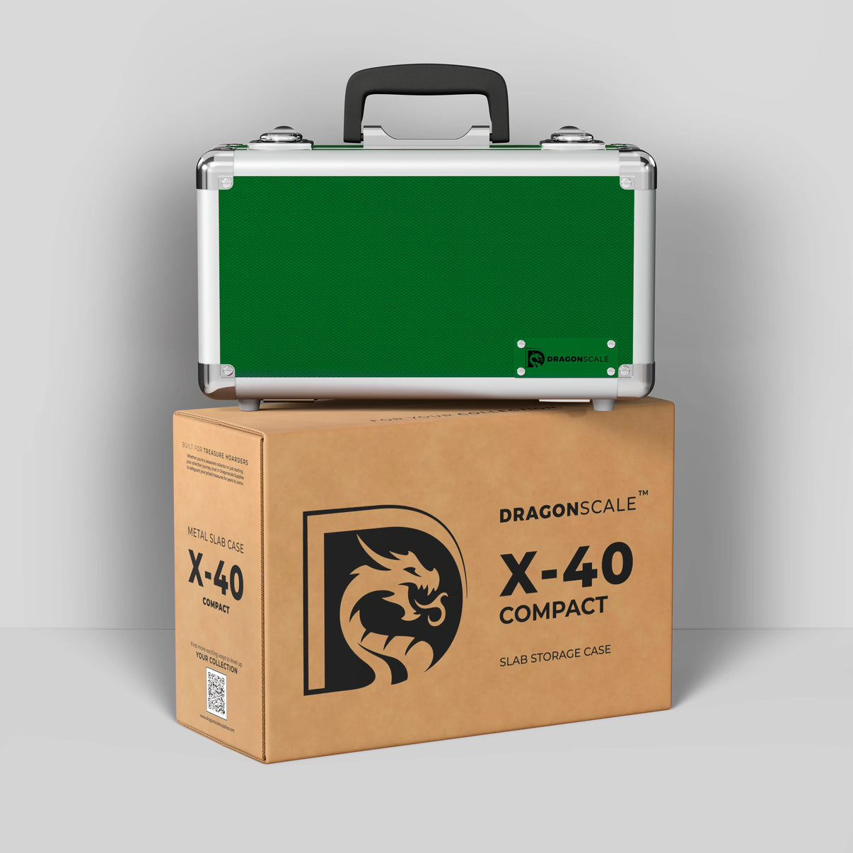 Display and demo view of the Dragonscale Basilisk X-40 Compact metal slab case in emerald green, placed on top of its branded cardboard packaging box.