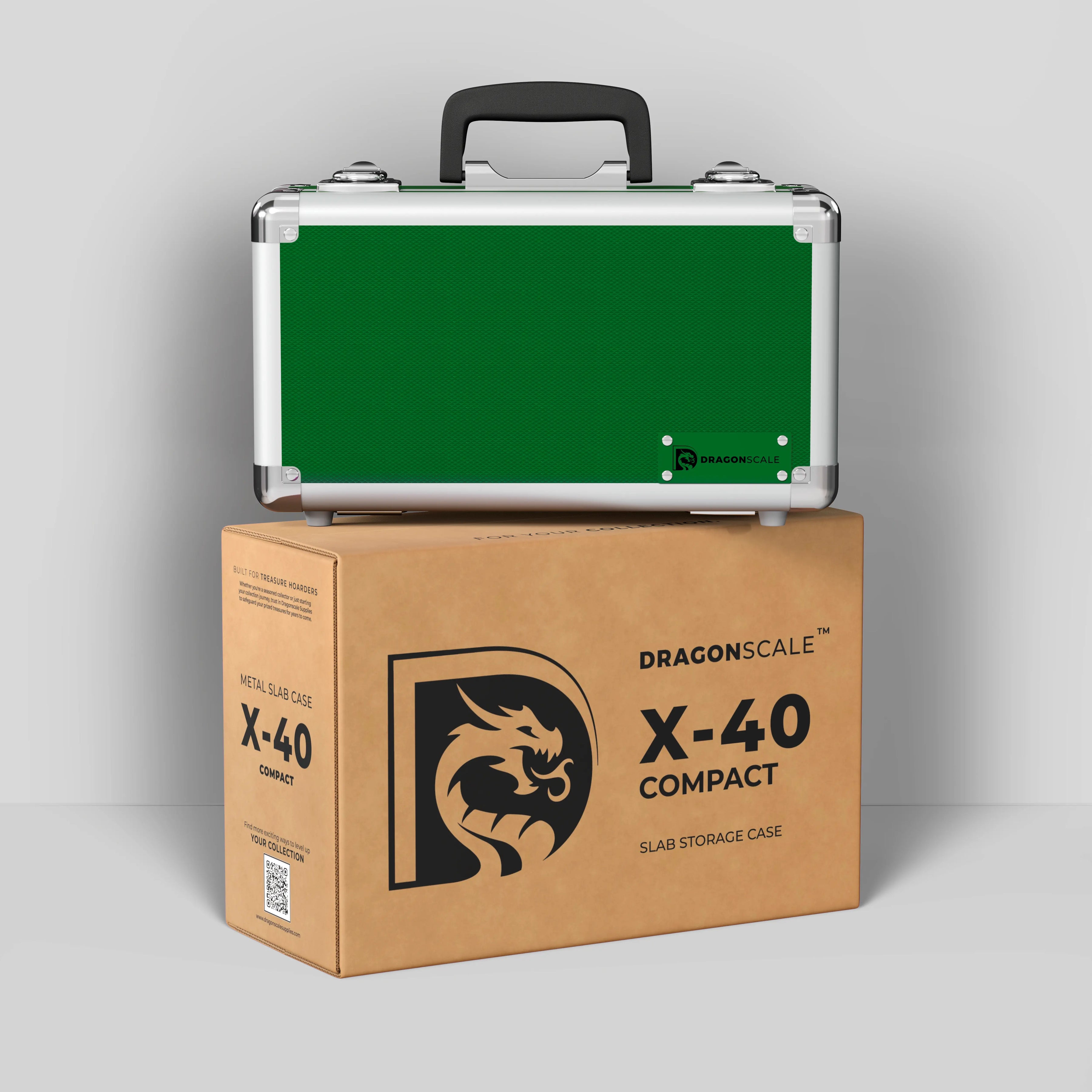 Display and demo view of the Dragonscale Basilisk X-40 Compact metal slab case in emerald green, placed on top of its branded cardboard packaging box.