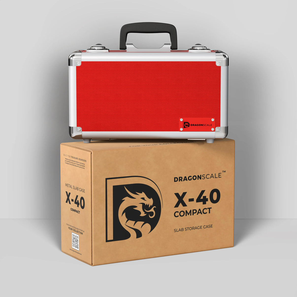Display and demo view of the Dragonscale Basilisk X-40 Compact metal slab case in ruby red, placed on top of its branded cardboard packaging box.