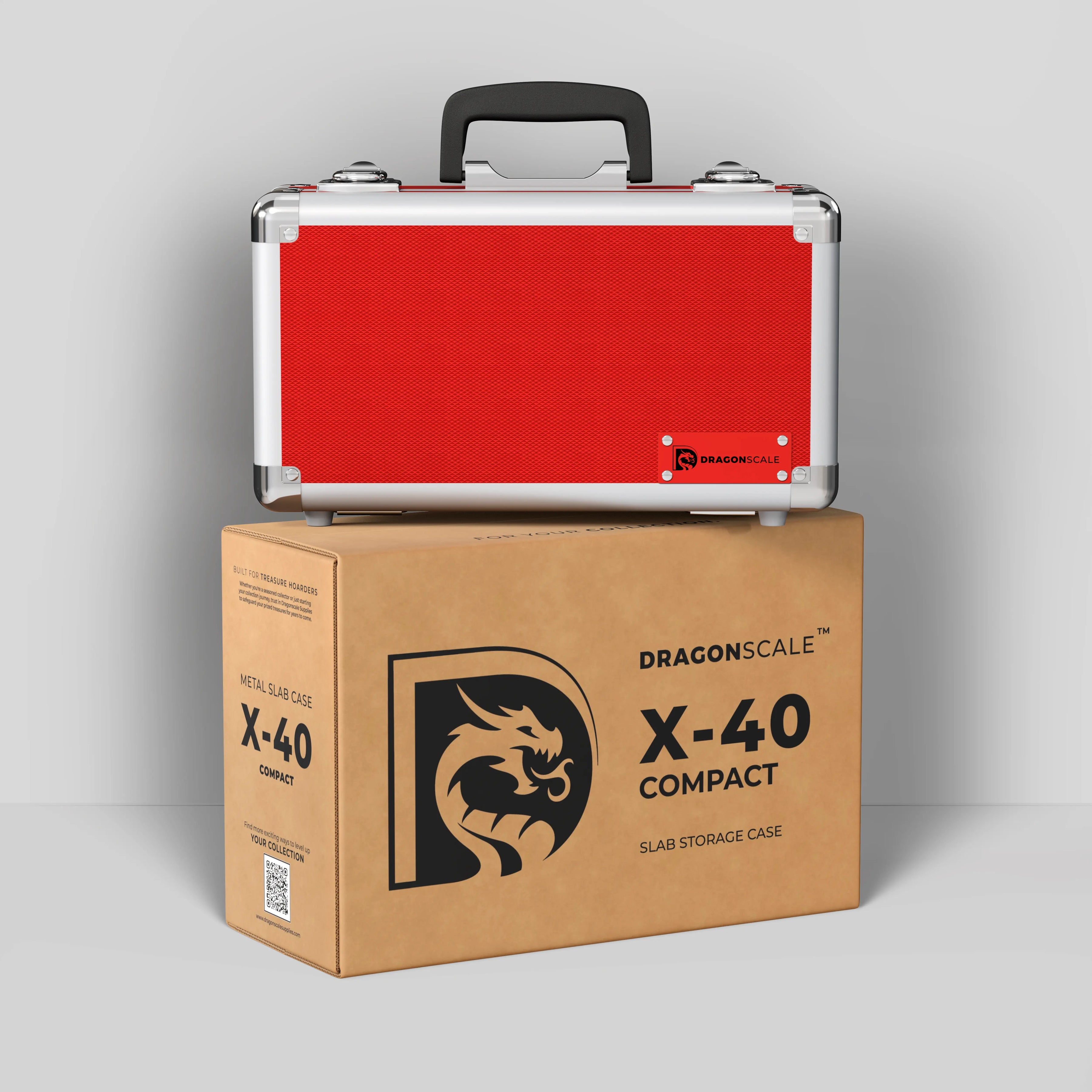 Display and demo view of the Dragonscale Basilisk X-40 Compact metal slab case in ruby red, placed on top of its branded cardboard packaging box.