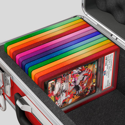Close-up of the Dragonscale Basilisk X-40 Compact metal slab case in ruby red foam slot securely holding PSA slabs with Dragonscale guards.