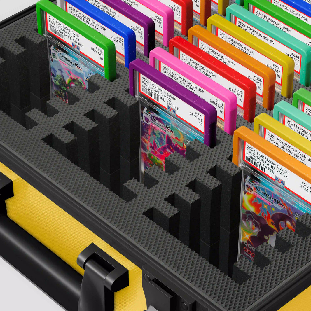 Close-up of the Dragonscale Behemoth XL-45 metal slab case in yellow foam slot securely holding PSA slabs with Dragonscale guards.