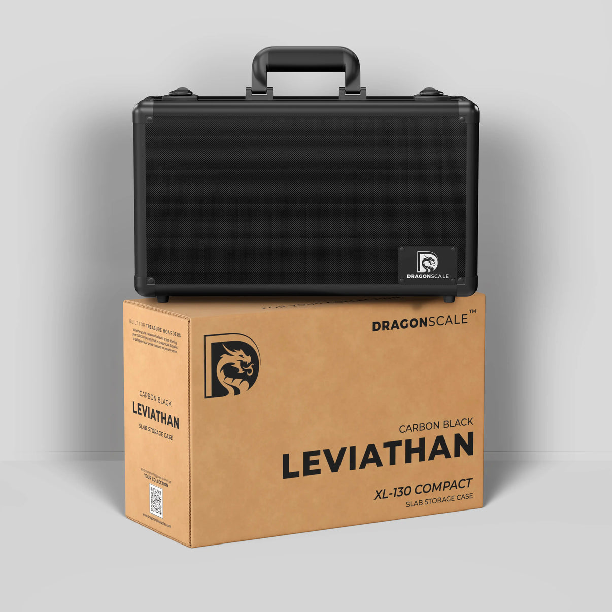 Display and demo view of the Dragonscale Leviathan XL-130 Compact metal slab case in carbon black, placed on top of its branded cardboard packaging box.