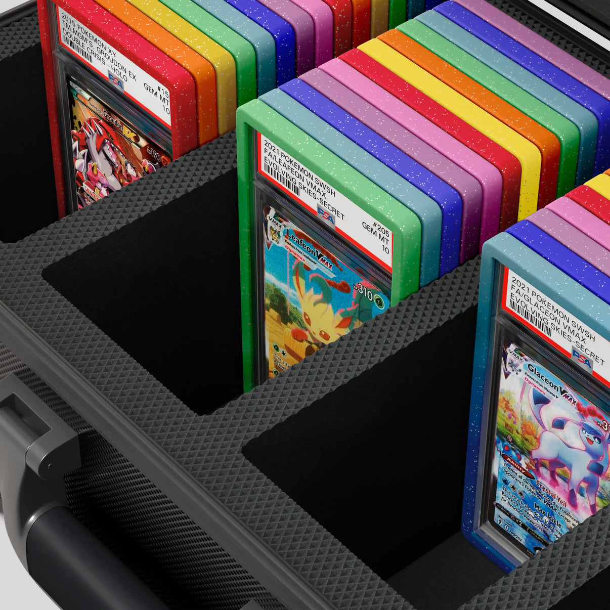 Close-up of the  Dragonscale Leviathan XL-130 Compact metal slab case in carbon black foam slot securely holding PSA slabs with Dragonscale guards.