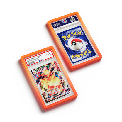 Top-down flat view of a PSA slab in Gradient Blaze Dragonscale bumper guard, featuring a Flareon VMAX Evolving Skies PSA 10 Pokemon card.