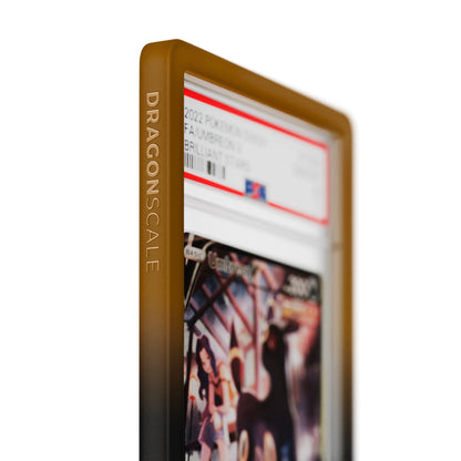 Close up logo zoom view of a PSA slab in Gradient Umbra Dragonscale bumper guard, featuring a Umbreon V Brilliant Stars PSA 10 Pokemon card.
