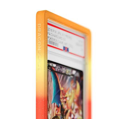 Close up logo zoom view of a PSA slab in Mythic Overheat Dragonscale bumper guard, featuring a Charizard Ex Japanese XY Promos PSA 10 Pokemon card.