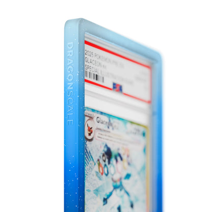 Close up logo zoom view of a PSA slab in Mythic Permafrost Dragonscale bumper guard, featuring a Glaceon Ex Prismatic Evolution PSA 10 Pokemon card.