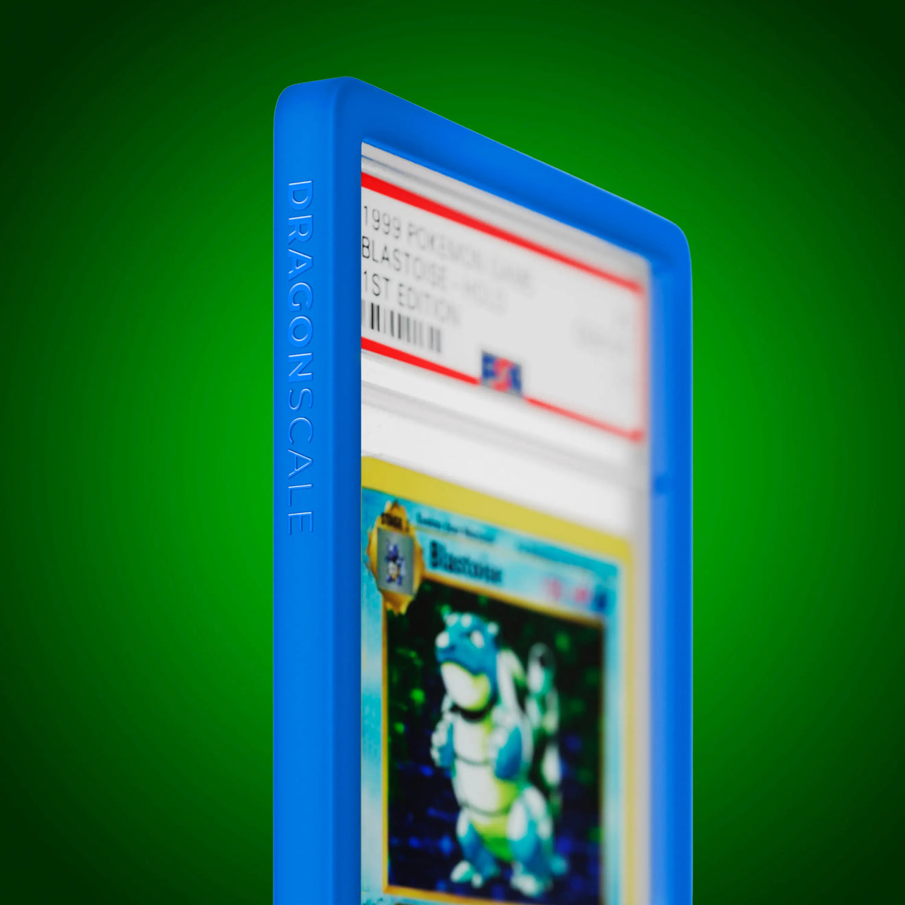 Close up logo zoom view of a PSA slab in Solid Blue Dragonscale bumper guard, featuring a Blastoise 1st Edition Base Set PSA 10 Pokemon card.