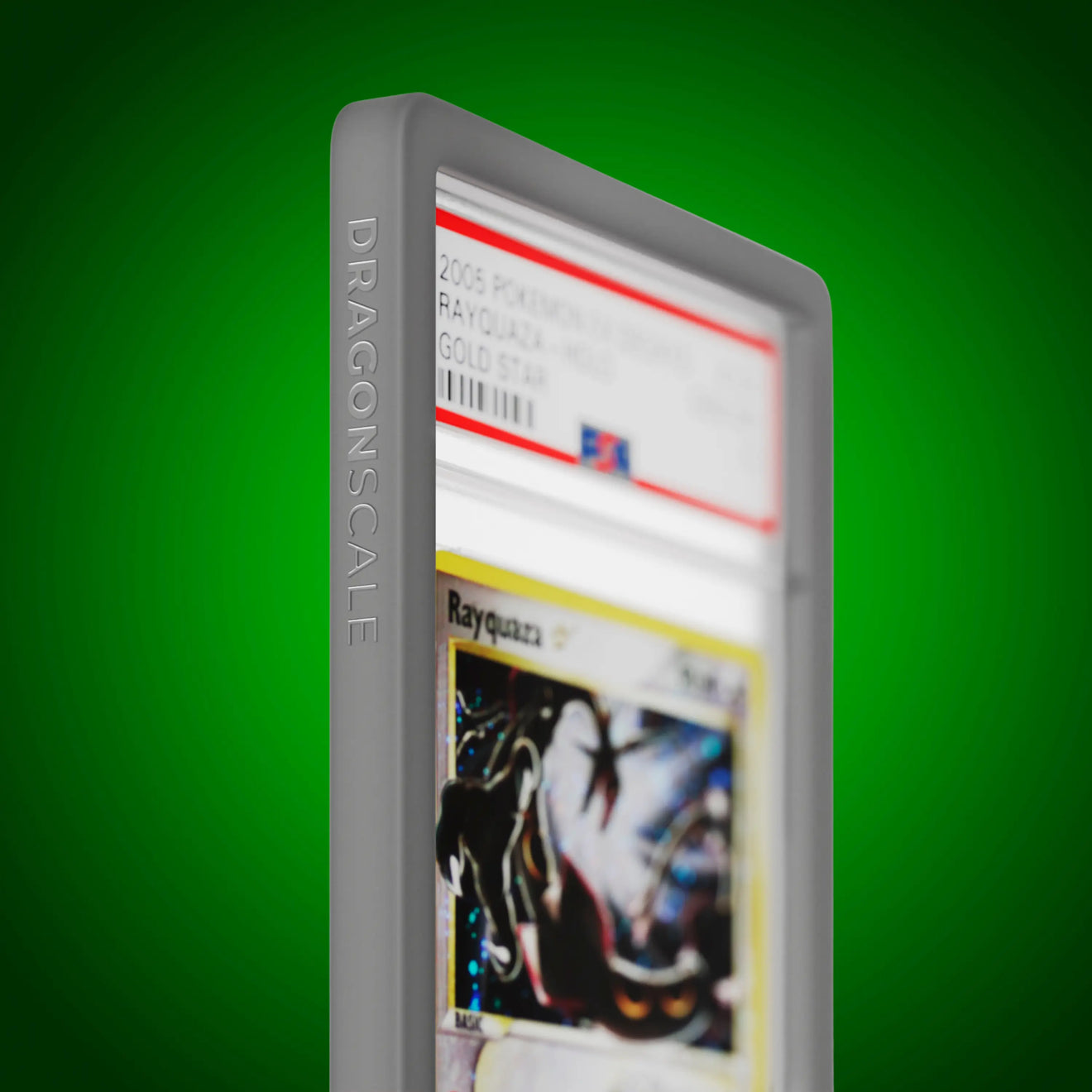 Close up logo zoom view of a PSA slab in Solid Grey Dragonscale bumper guard, featuring a Rayquaza Gold Star Ex Deoxys PSA 10 Pokemon card.