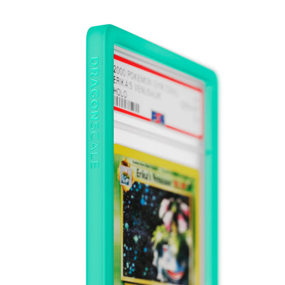 Close up logo zoom view of a PSA slab in Solid Mint Dragonscale bumper guard, featuring a Erika’s Venusaur Gym Heroes PSA 10 Pokemon card.