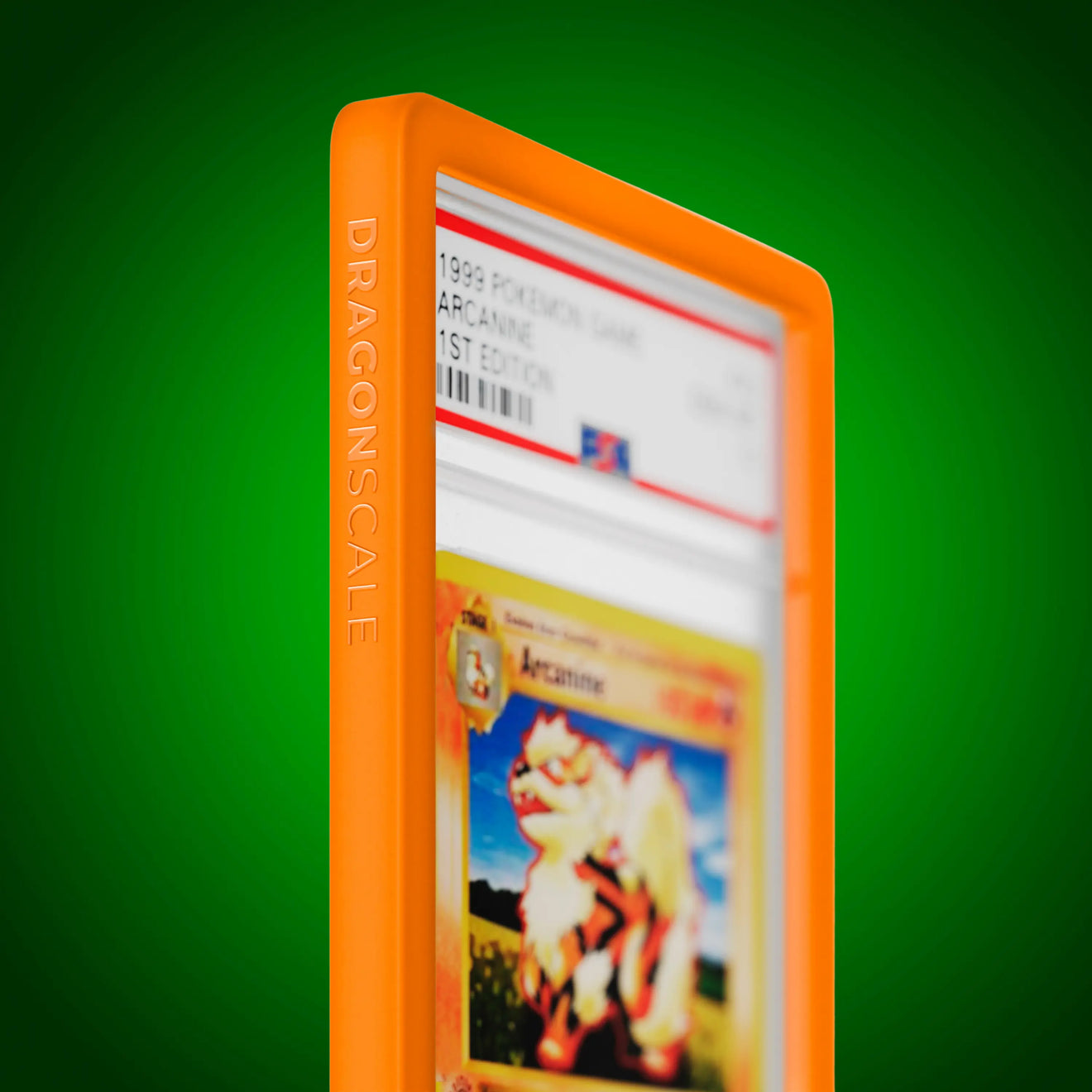 Close up logo zoom view of a PSA slab in Solid Orange Dragonscale bumper guard, featuring a Arcanine 1st Edition Base Set PSA 10 Pokemon card.