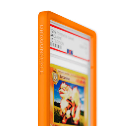 Close up logo zoom view of a PSA slab in Solid Orange Dragonscale bumper guard, featuring a Arcanine 1st Edition Base Set PSA 10 Pokemon card.