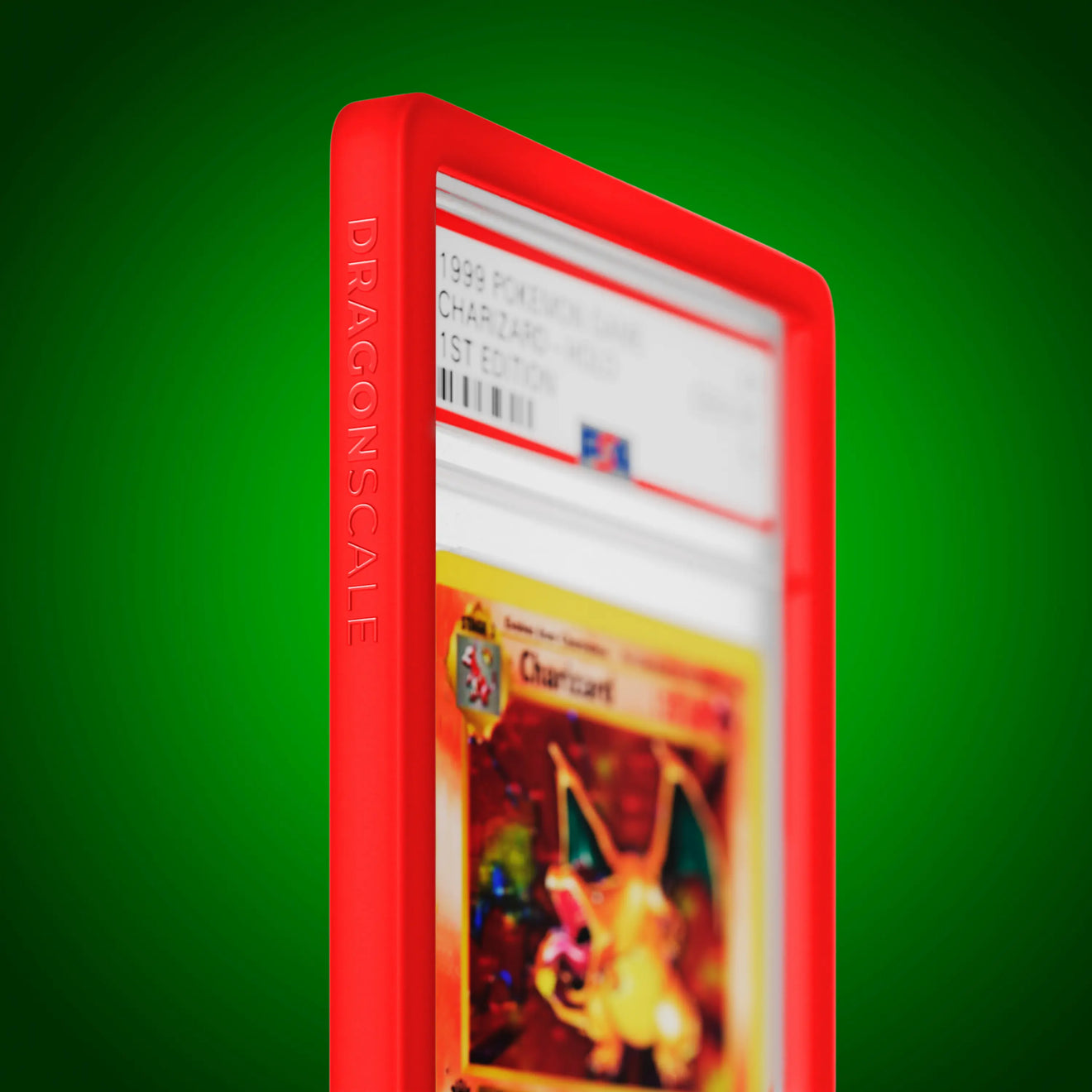 Close up logo zoom view of a PSA slab in Solid Red Dragonscale bumper guard, featuring a Charizard 1st Edition Base Set PSA 10 Pokemon card.