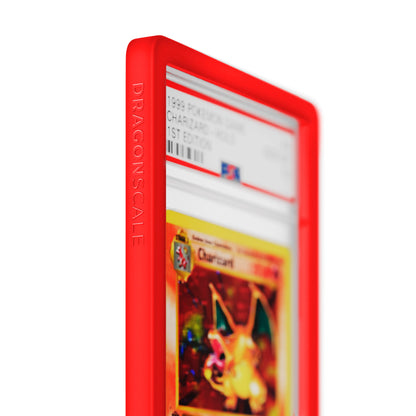 Close up logo zoom view of a PSA slab in Solid Red Dragonscale bumper guard, featuring a Charizard 1st Edition Base Set PSA 10 Pokemon card.