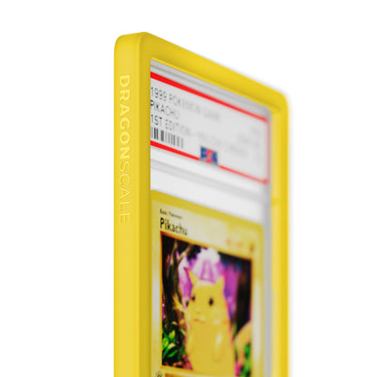 Close up logo zoom view of a PSA slab in Solid Yellow Dragonscale bumper guard, featuring a Pikachu 1st Edition Base Set PSA 10 Pokemon card.
