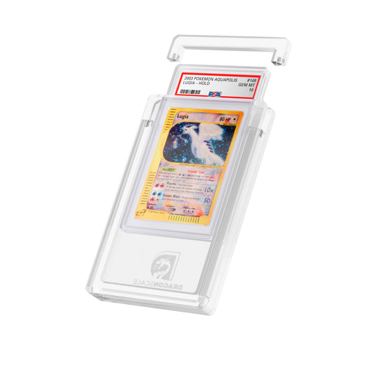 Angled display and demo view of the Dragonscale Wyrmgem Solid Clear acrylic case, highlighting the acrylic lid and secure magnetic locks featuring a  Aquapolis Lugia Holo PSA 10 Pokemon card.