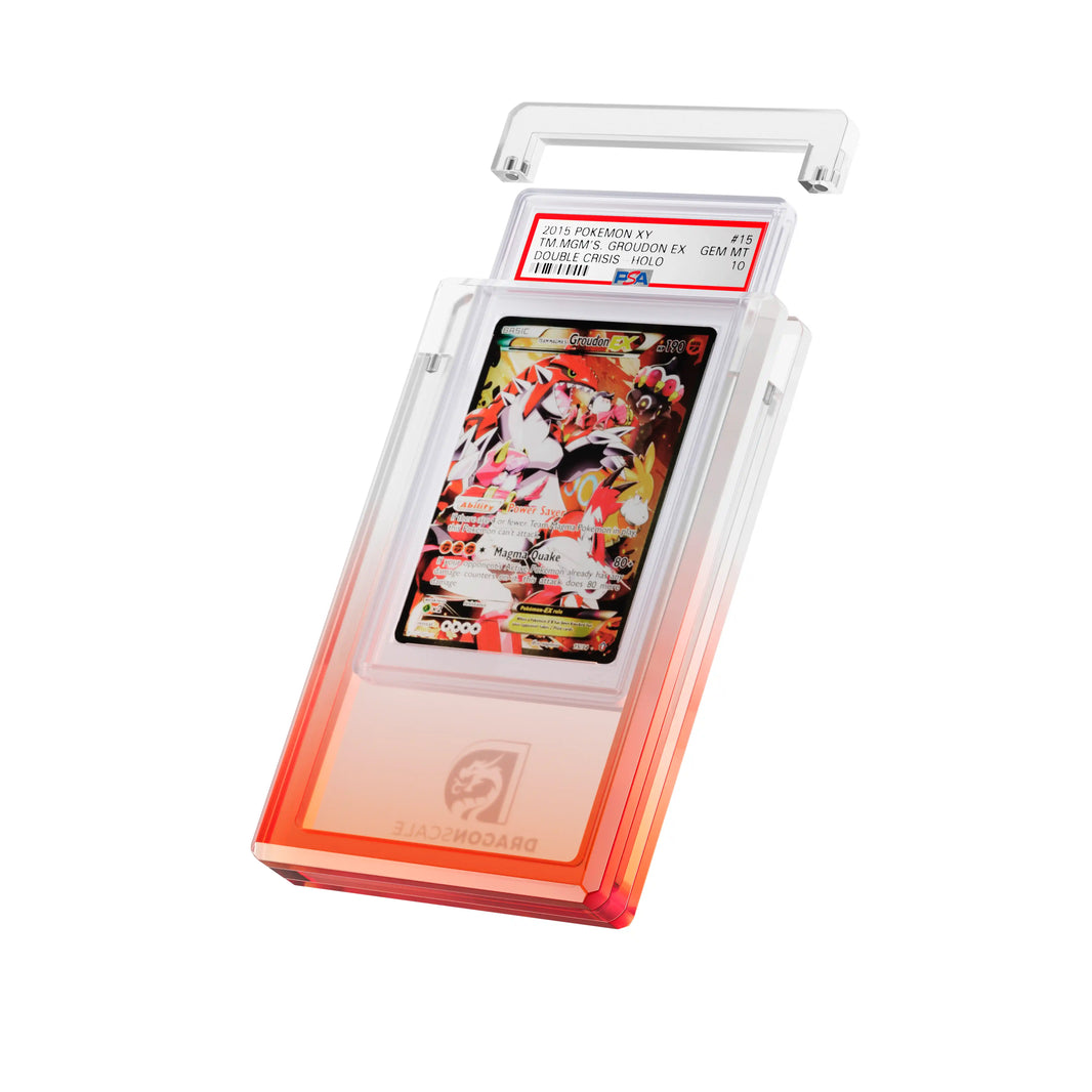 Angled display and demo view of the Dragonscale Wyrmgem Myst Ruby acrylic case, highlighting the acrylic lid and secure magnetic locks featuring a Team Magmas Groudon Ex PSA 10 Pokemon card.