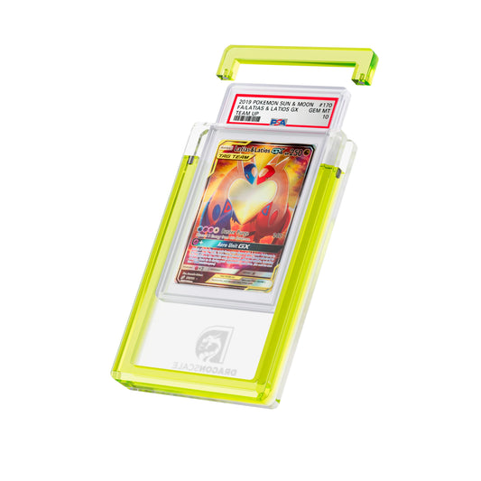 Angled display and demo view of the Dragonscale Wyrmgem Solid Topaz acrylic case, highlighting the acrylic lid and secure magnetic locks featuring a Latias & Latios GX PSA 10 Pokemon card.