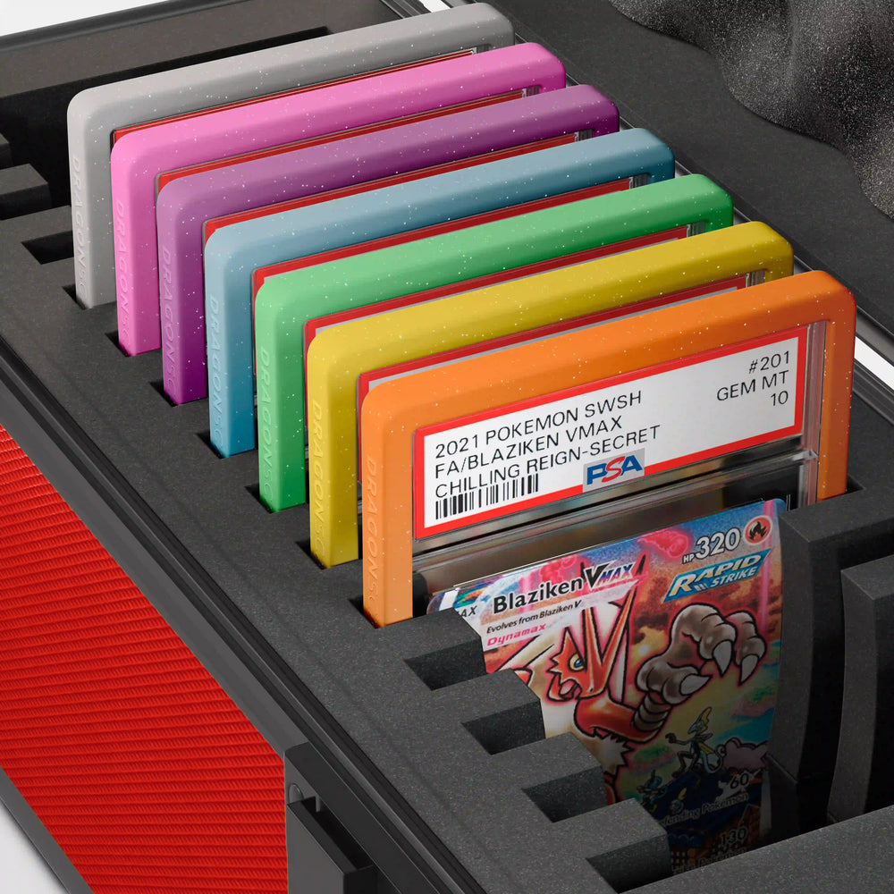 Close-up of the Dragonscale Wyvern X-15 Precision metal slab case in ruby red foam slot securely holding PSA slabs with Dragonscale guards.