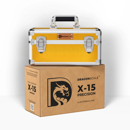 Display and demo view of the Dragonscale X-15 Precision metal slab case in shiny gold, placed on top of its branded cardboard packaging box.