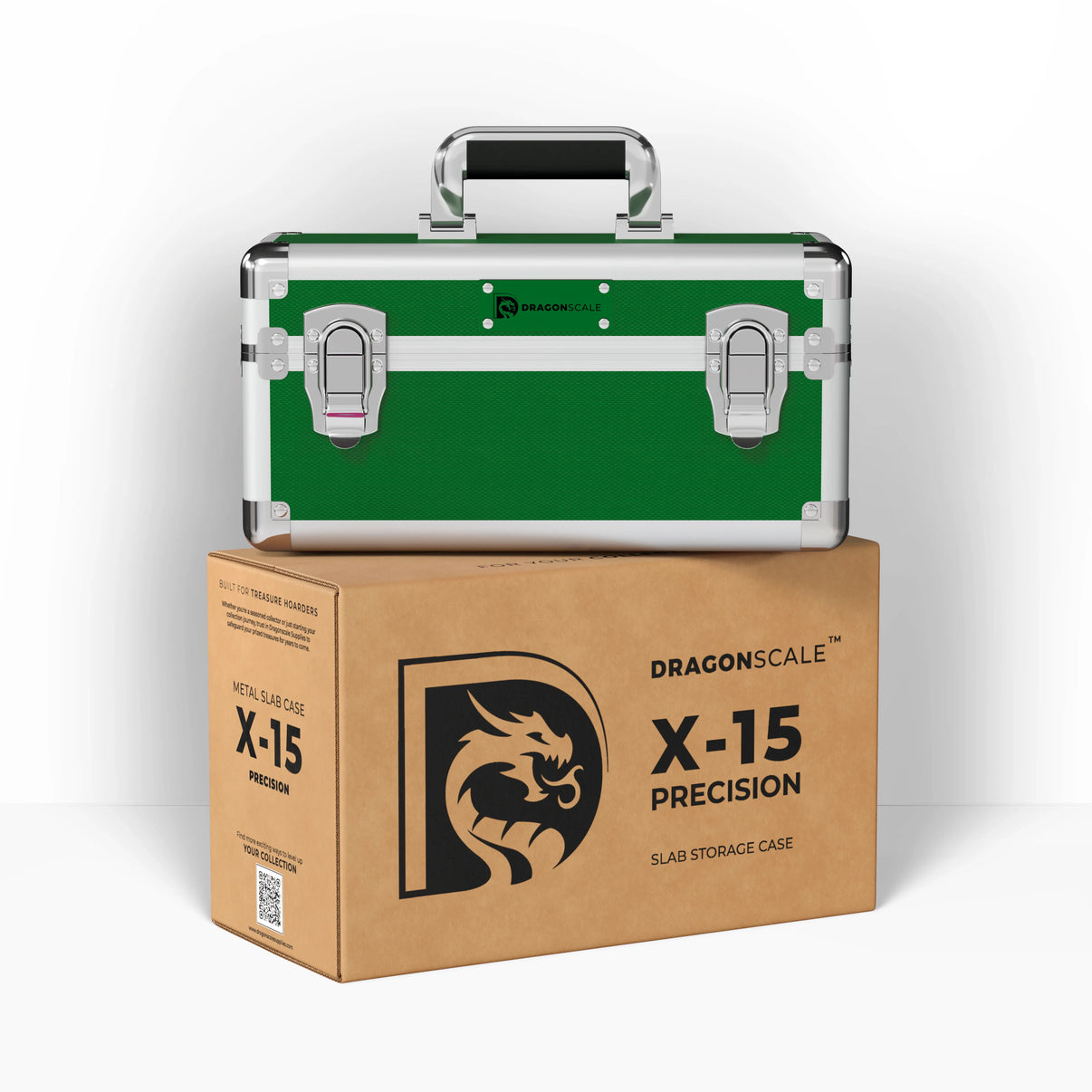 Display and demo view of the Dragonscale X-15 Precision metal slab case in emerald green, placed on top of its branded cardboard packaging box.