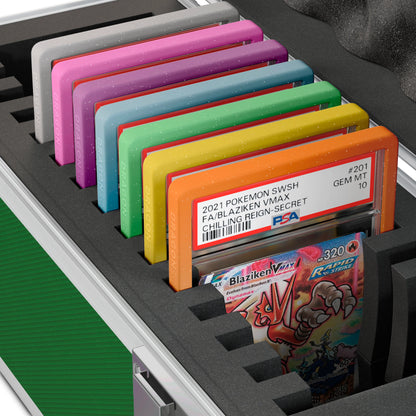 Close-up of the Dragonscale X-15 Precision metal slab case in emerald green foam slot securely holding PSA slabs with Dragonscale guards.