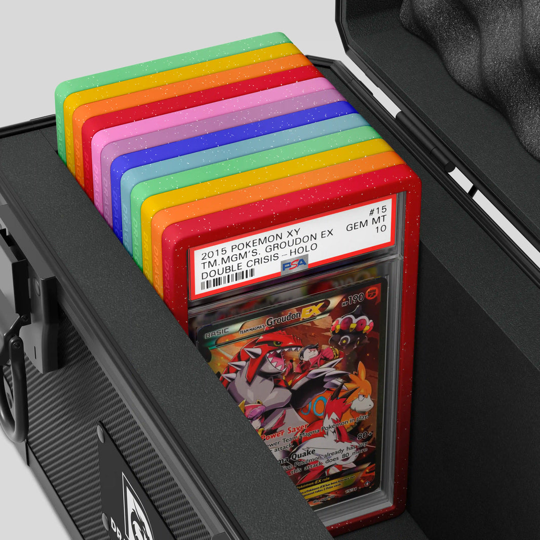 Close-up of the Dragonscale XC-Titan metal slab case in carbon black foam slot securely holding PSA slabs with Dragonscale guards.